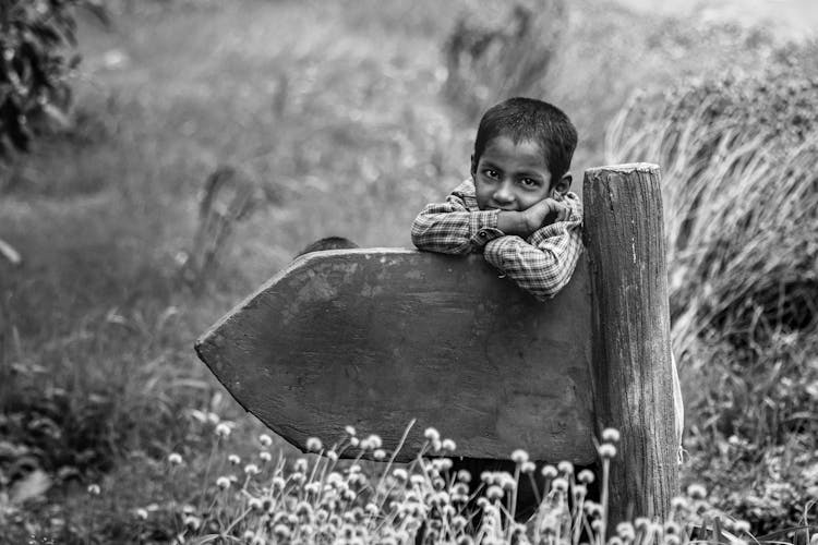  Boy Leaning On The Wooden Pole Sign