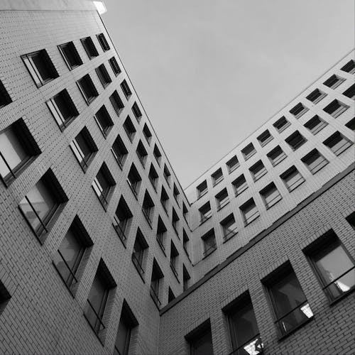 Free Monochrome Photograph of a Brick Building with Windows Stock Photo