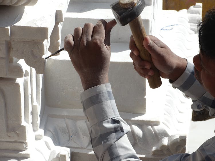 Man Carving In Stone 