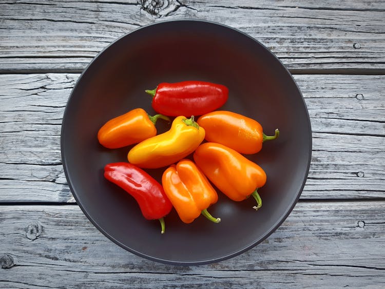 Overhead Shot Of Bell Peppers In A Black Bowl