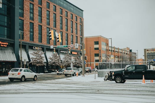 Bustling city street in Washington DC during winter with snow-covered roads and vibrant shops.