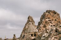 Amazing view of ancient houses carved out of volcanic formations in Cappadocia in overcast weather
