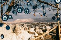 Amulets made of blue glass reminding eye hanging on tree branches in Cappadocia