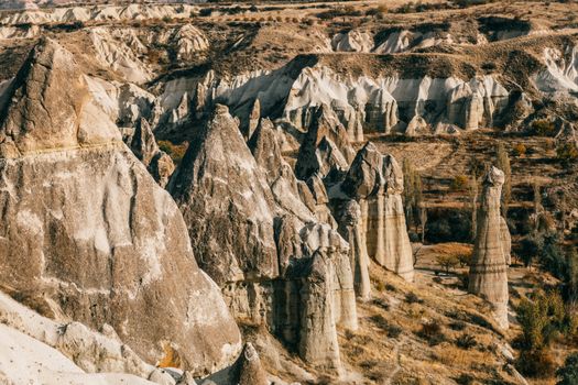 Fairy chimneys in rocky terrain on sunny day