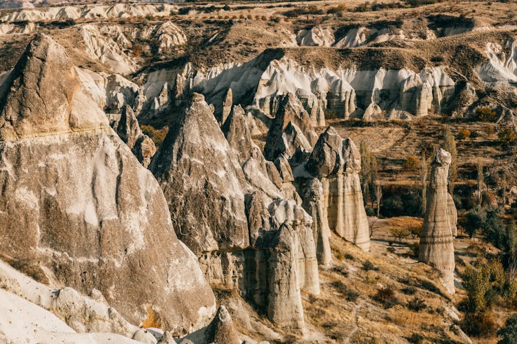 Fairy Chimneys In Rocky Terrain On Sunny Day