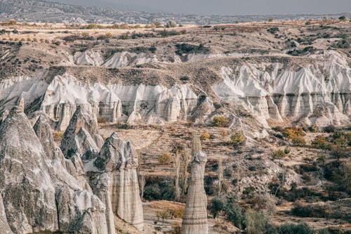 Free Rocky formations in highlands in Cappadocia with mountains and plants Stock Photo