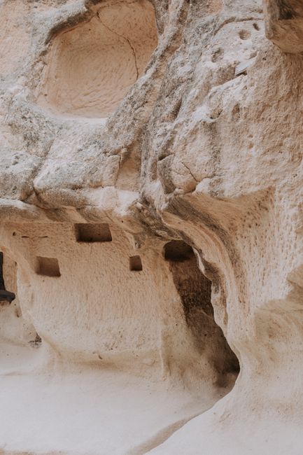 Stony uneven mountains with rough massive texture and various holes on formations in daylight