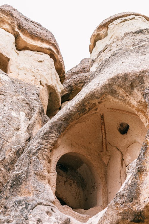 Free From below of aged stone monastery located in old rough mountains of Cappadocia in Turkey Stock Photo