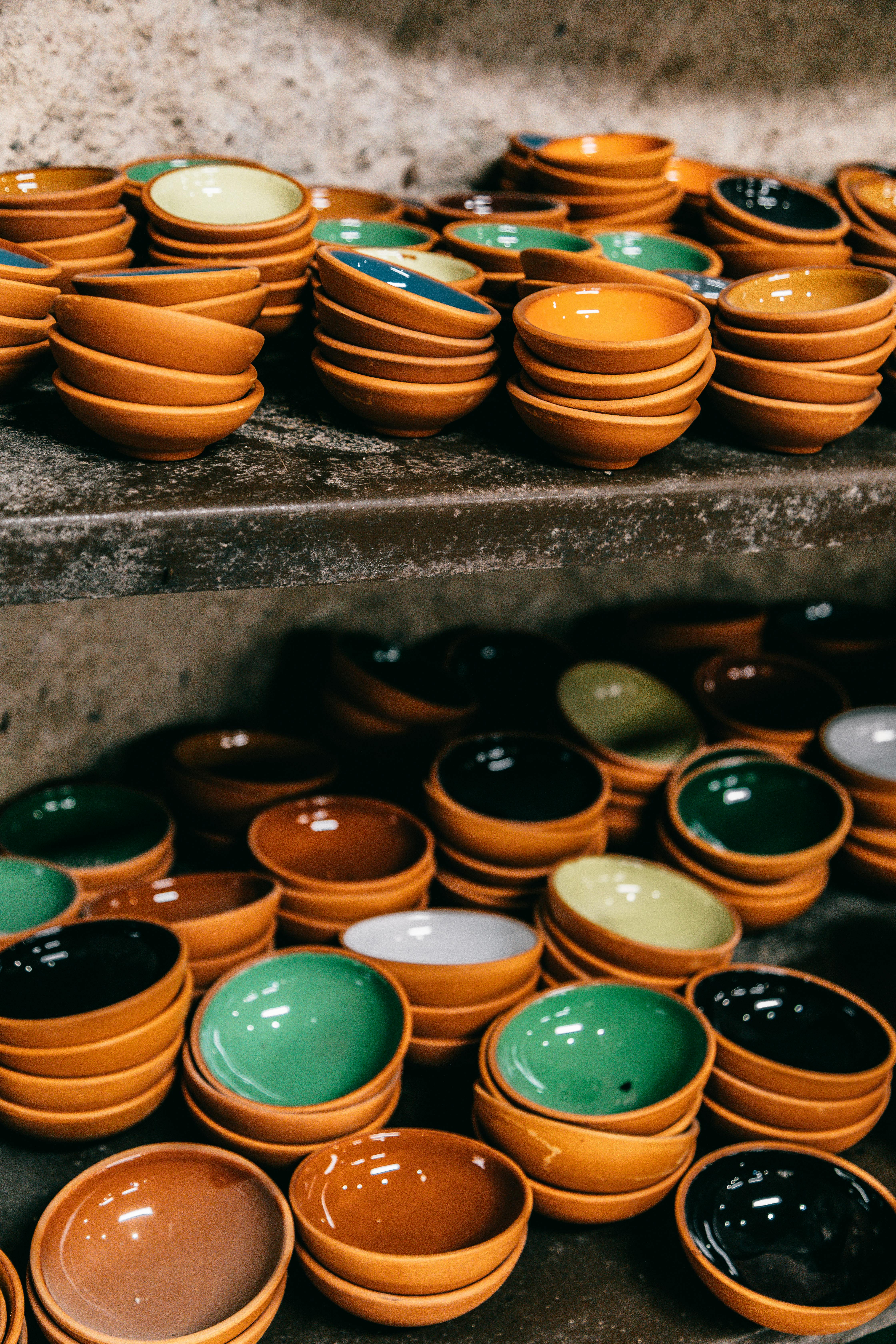 collection of bright ceramic bowls on shelves