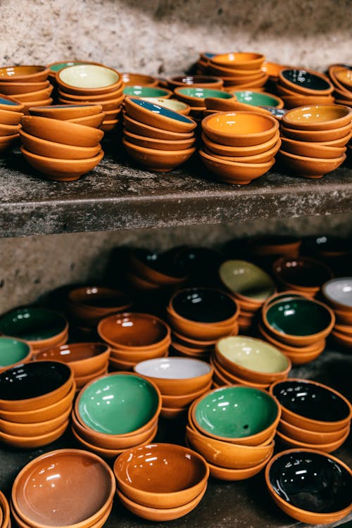 Collection of bright ceramic bowls on shelves