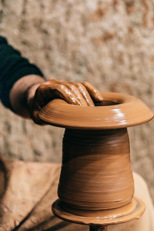 Free Person doing clay modeling on pottery wheel Stock Photo