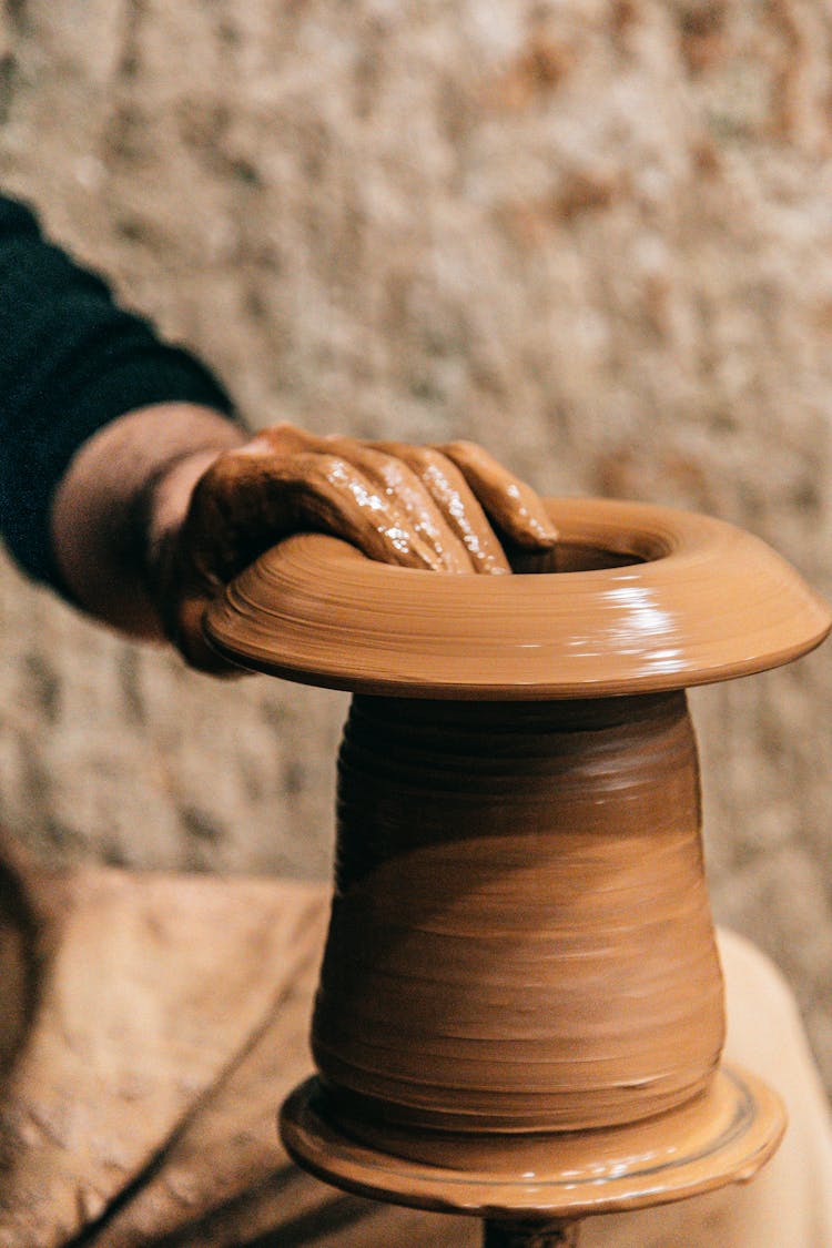 Person Doing Clay Modeling On Pottery Wheel