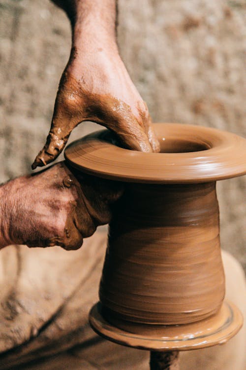 Professional master making vase on pottery wheel