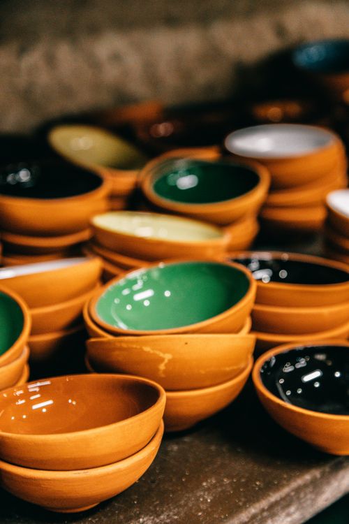 Free Many bright ceramic empty bowls placed on shelf in local market of town Stock Photo