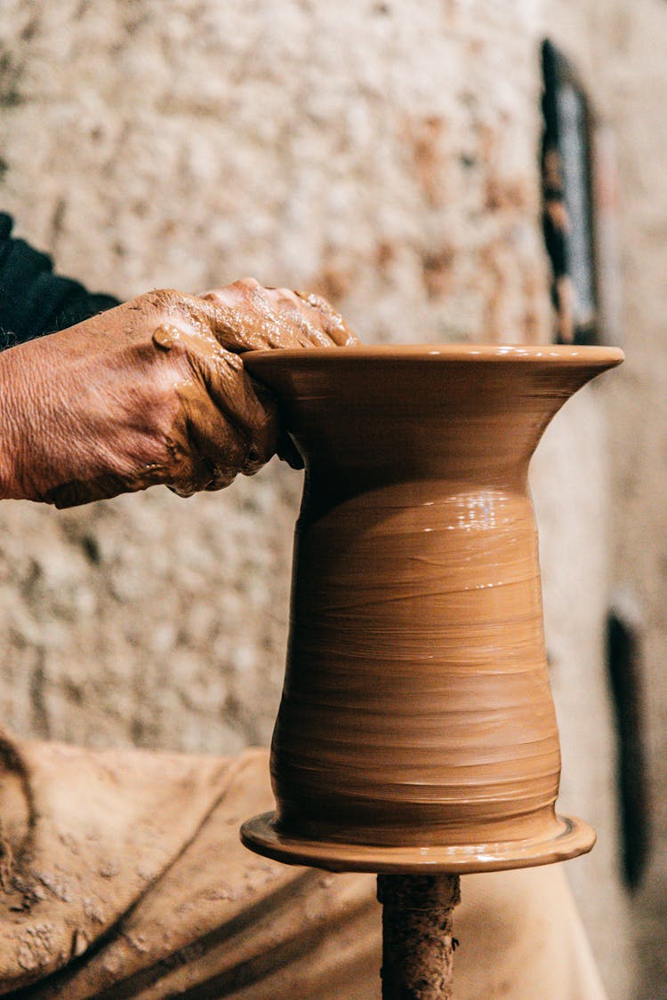 Experienced Craftsman Sculpting Vase With Clay And Pottery Wheel