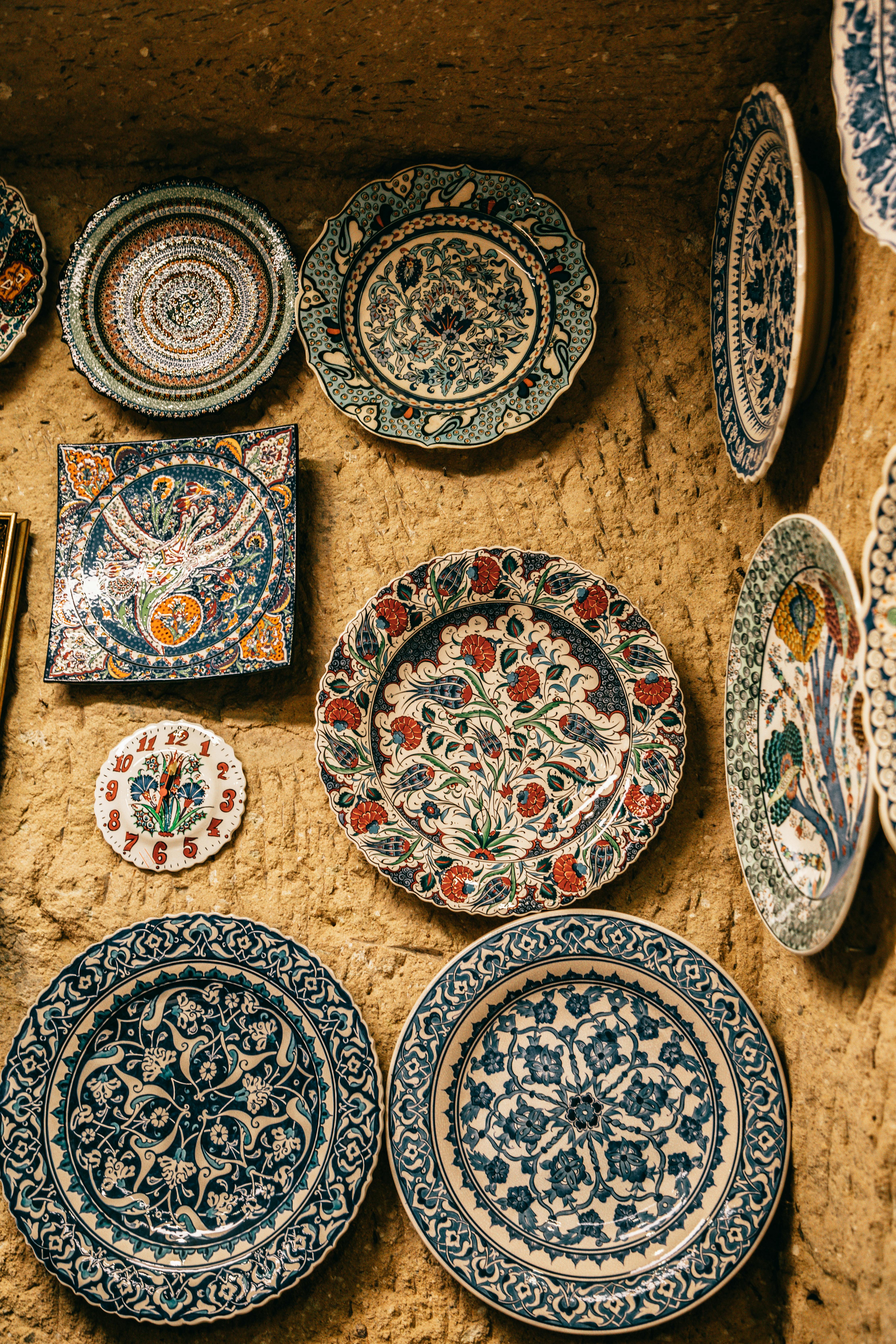 bright decorative ceramic plates with ornaments on stone wall