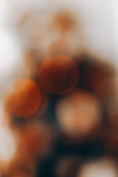 Abstract creative background of brown bokeh lights and blurred object on gray backdrop