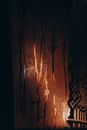 From inside bright orange lights glowing behind steamy window glass at dark night