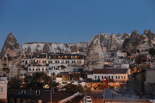 Aged residential houses of settlement Goreme located among rock formations in historical region of Turkey in evening