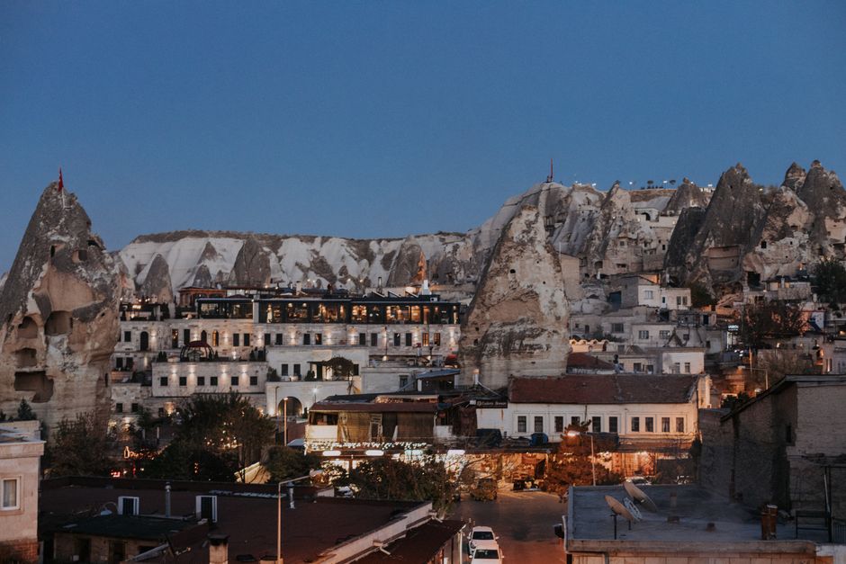 Aged residential houses of settlement Goreme located among rock formations in historical region of Turkey in evening in Göreme