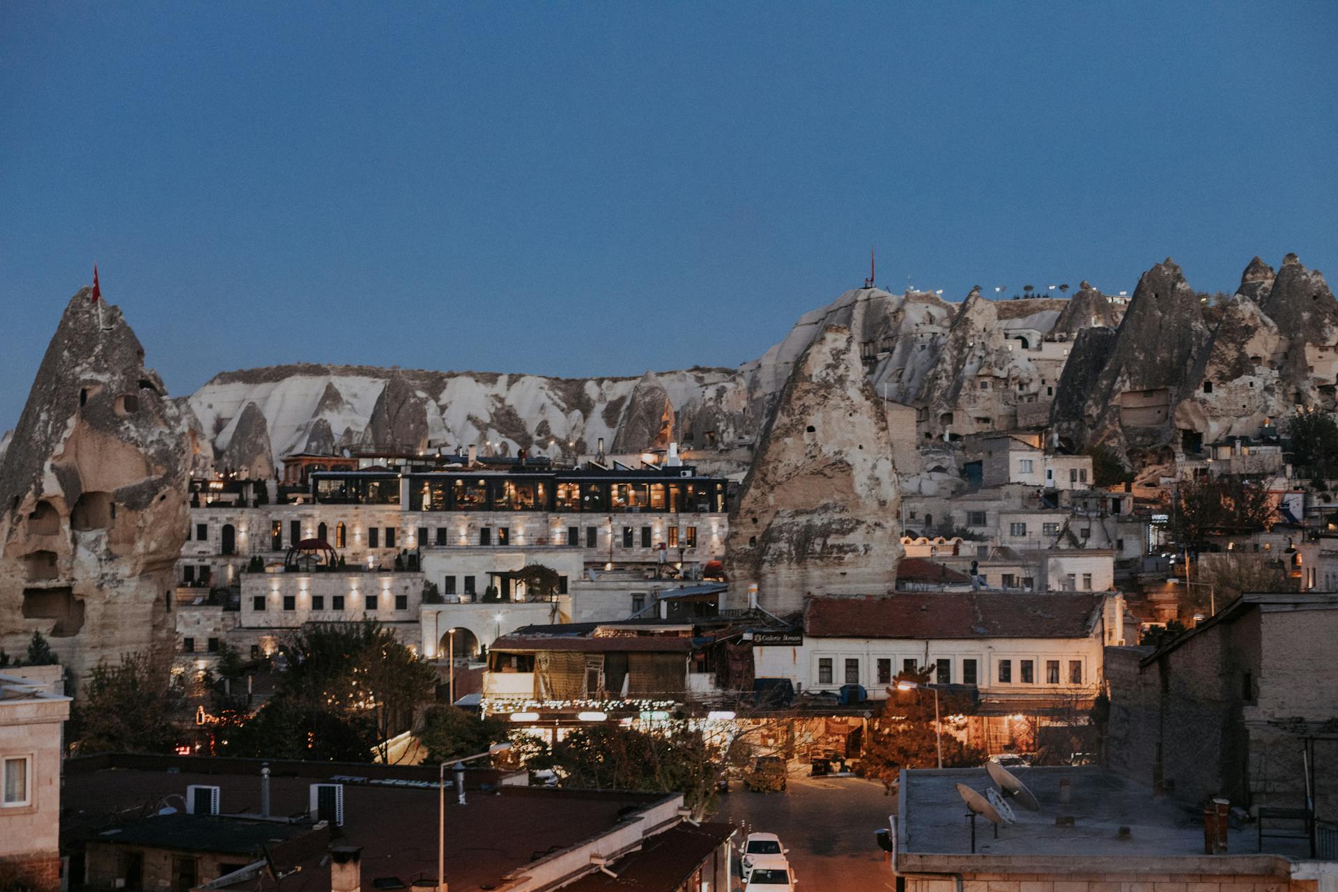 Aged residential houses of settlement Goreme located among rock formations in historical region of Turkey in evening