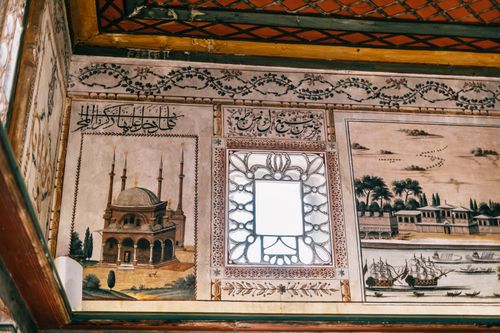 Free From below of mosaic and paintings on wall and decorated ceiling with ornamental elements in oriental style home with vintage design Stock Photo
