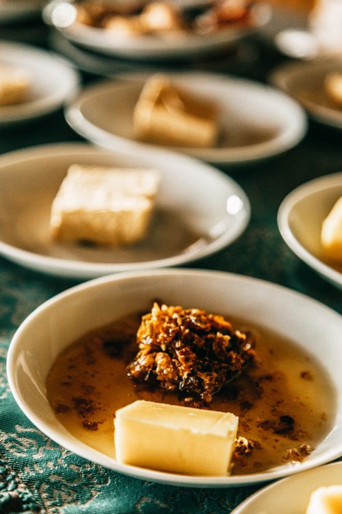 Free Haute cuisine with tasty meal served in white ceramic bowl on table with cloth against various dishes on blurred background in restaurant Stock Photo