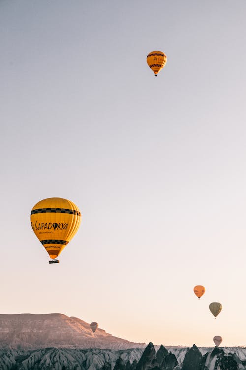 Free Air balloon flying over highlands at dawn Stock Photo