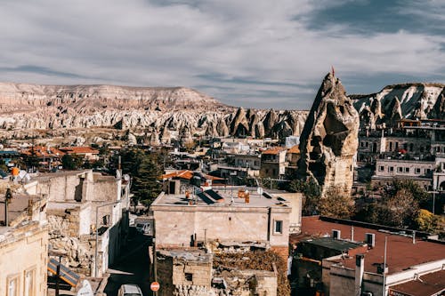 Aged stone buildings surrounded by rocky formations located in old region of Turkey