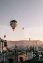 Air balloons over highlands and old stone buildings