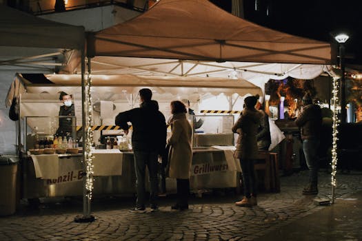 Captivating image of people at a nighttime street market with illuminated stalls, capturing a vibrant urban atmosphere.