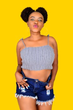 Portrait of a fashionable African woman posing in a casual outfit.