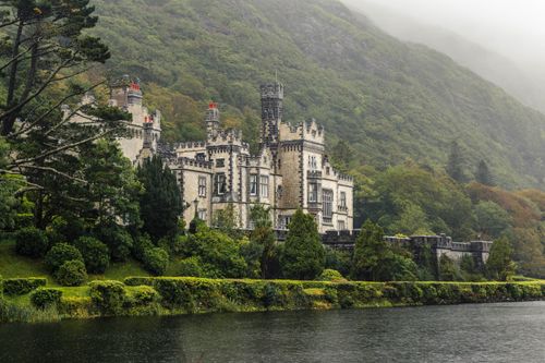 Free Beautiful view of Kylemore Abbey surrounded by lush greenery in Connemara, Ireland. Stock Photo