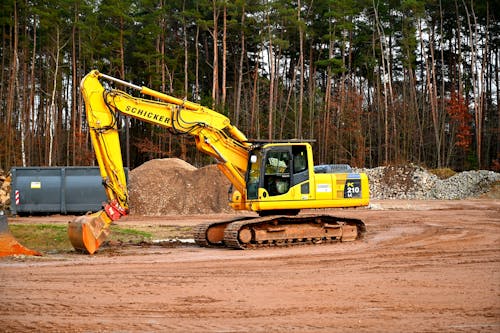 Free Yellow and Black Excavator on Brown Soil Stock Photo