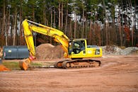 Yellow and Black Excavator on Brown Soil