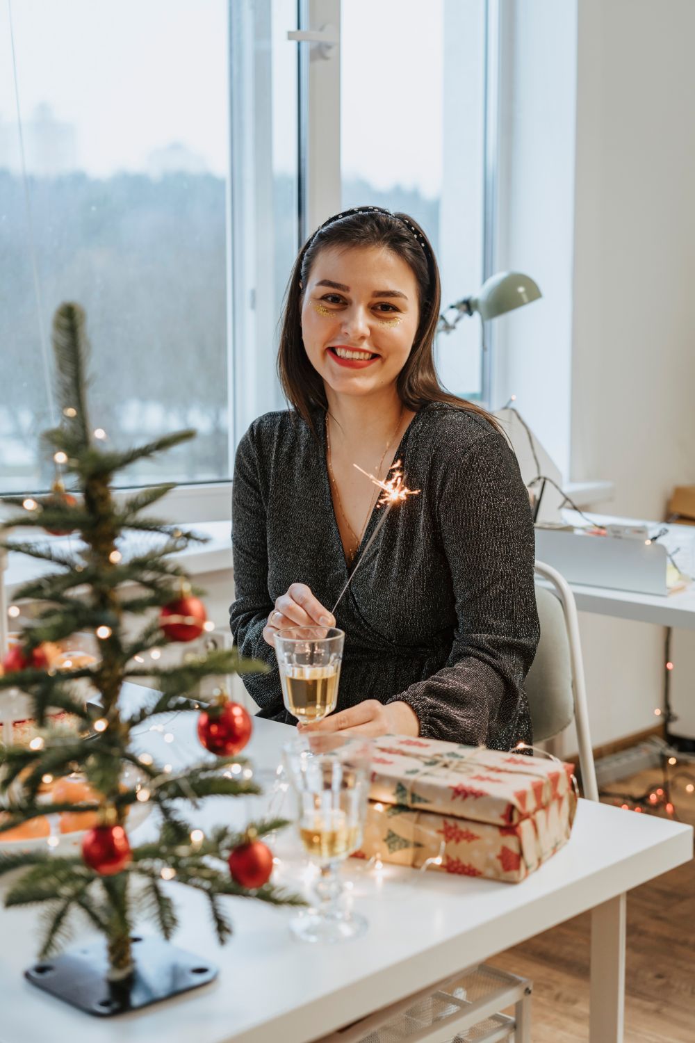 Photo of a Woman Smiling while Holding a Sparkler · Free Stock Photo