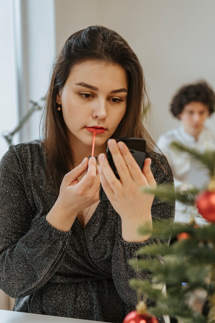 Photo Of A Woman Putting Lip Tint On Her Lips