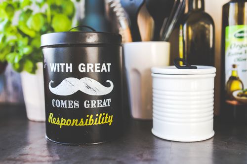 Free Black kitchen container with mustache design and humorous text. Stock Photo