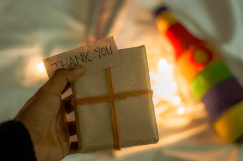 Free Photograph of a Person's Hand Holding a Gift Box Stock Photo