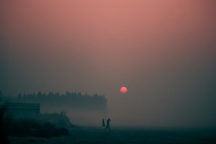 Person Walking On Street During Sunset