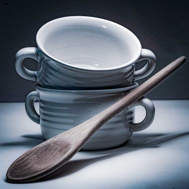 Stacked bowls with a wooden spoon — photo by Bill Bistak on Pexels
