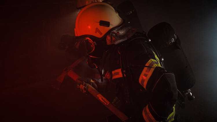 Photograph Of A Firefighter Holding An Axe