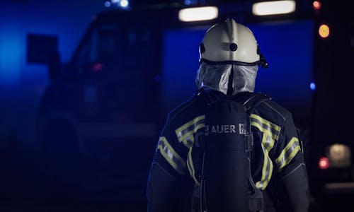 Back View of a Firefighter Wearing a White Helmet