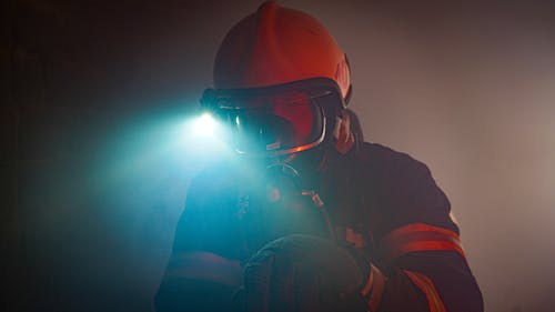 Photo of a Firefighter Wearing a Helmet with a Flashlight