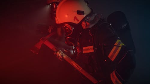 Photo of a Firefighter with a Helmet Holding an Axe