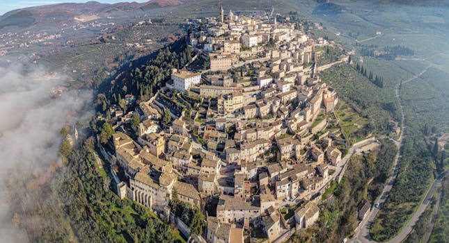 Drone view of medieval old San Marino city built on lush verdant hill in spacious valley