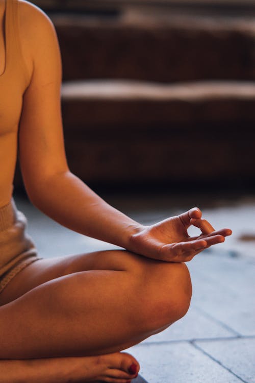 Photo of a Person Meditating while Sitting