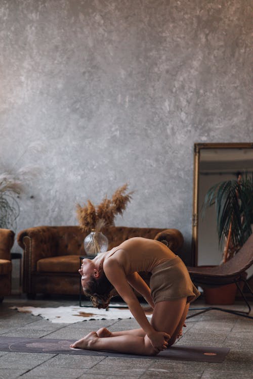 Photo of a Woman in a Brown Top Doing Yoga