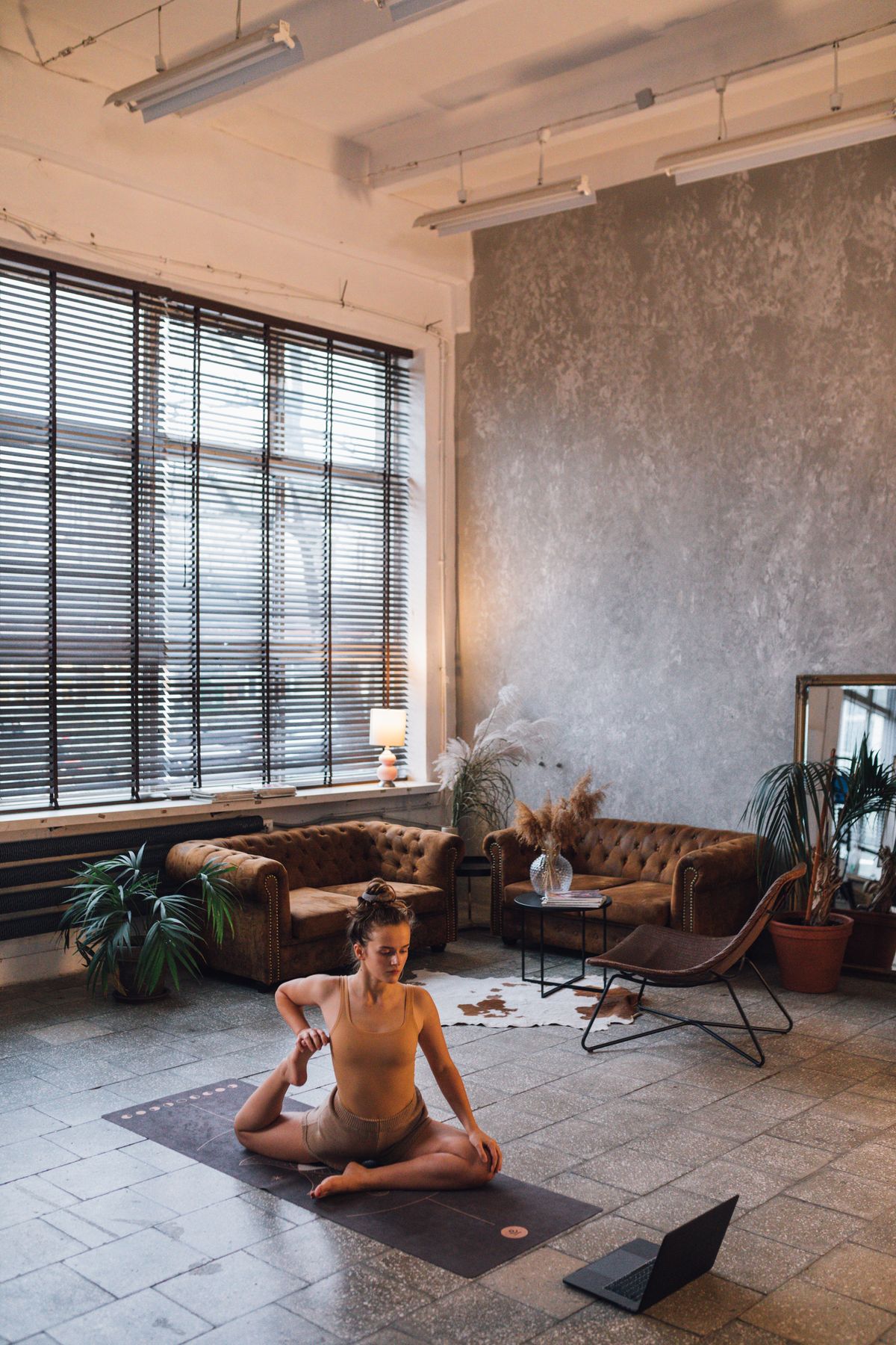 Woman doing yoga in her living room with natural lighting