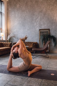 A woman doing yoga indoors, showcasing fitness, flexibility, and wellness.
